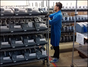 technician inspecting a rack of check scanners.