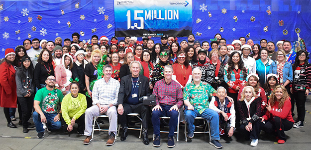 Entire Digital Check factory staff celebrating 1.5 million scanners produced at a December holiday party.